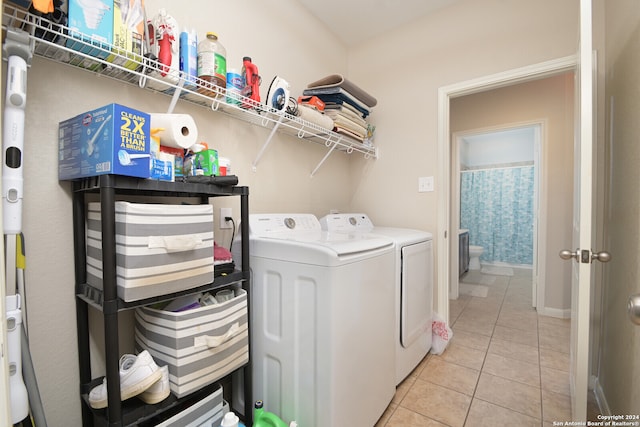 washroom featuring separate washer and dryer and light tile floors