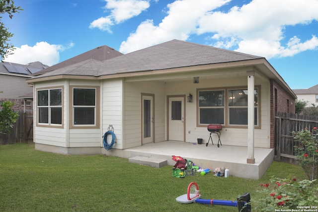 rear view of property with a yard and a patio