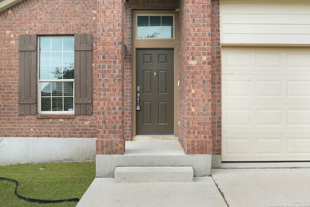 doorway to property with a garage