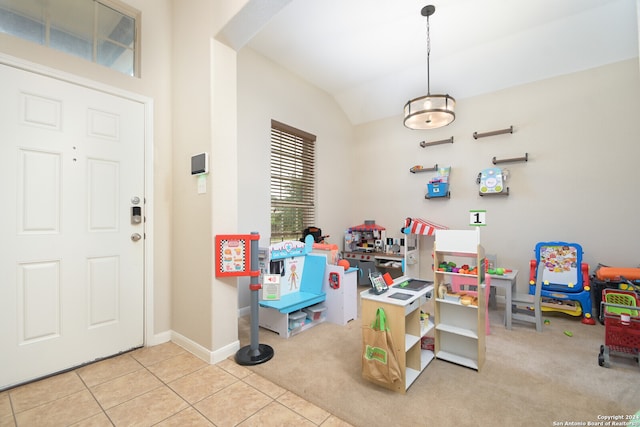 recreation room featuring light colored carpet and vaulted ceiling