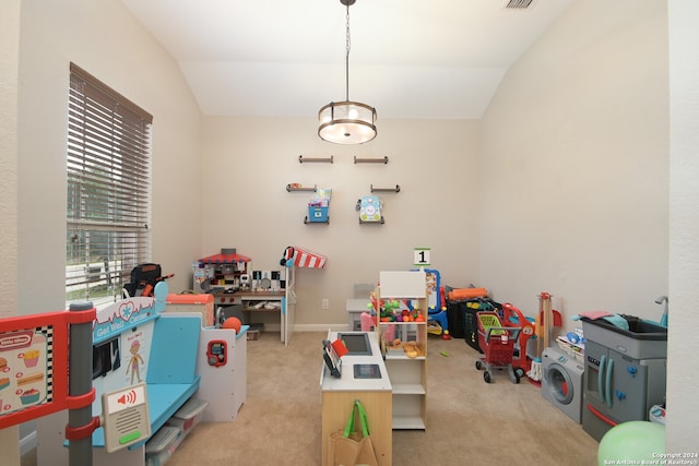 recreation room with lofted ceiling, carpet, and washer / dryer