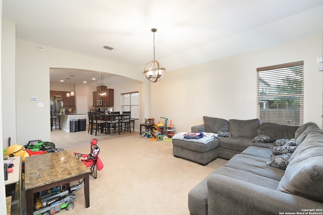 living room featuring a chandelier and light tile floors