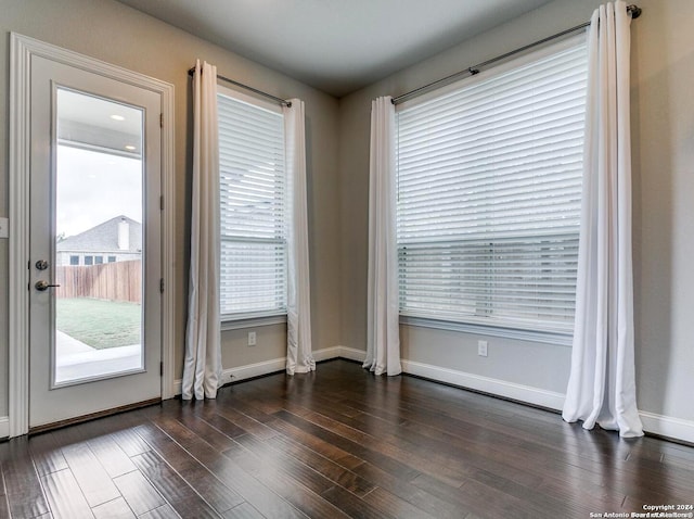 unfurnished room with dark hardwood / wood-style floors