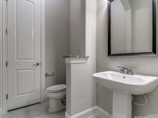 bathroom with tile floors and toilet