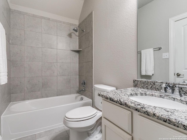 full bathroom with tile flooring, tiled shower / bath, toilet, and large vanity