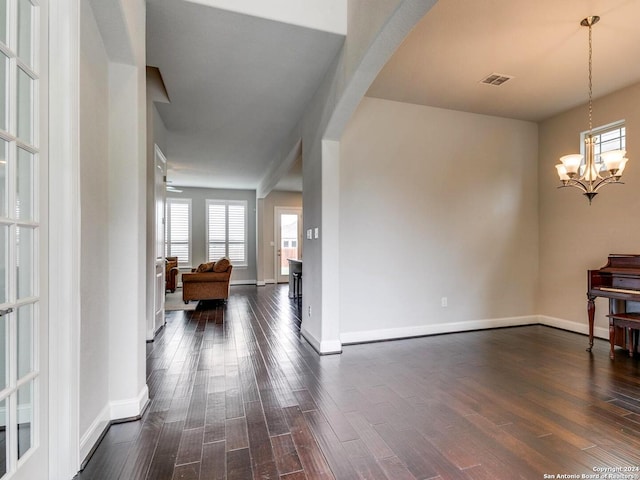 interior space with a chandelier and dark wood-type flooring