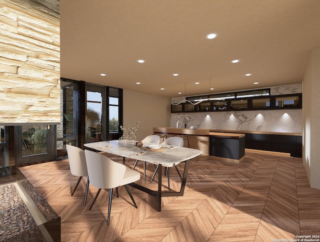 dining space with light parquet floors and sink