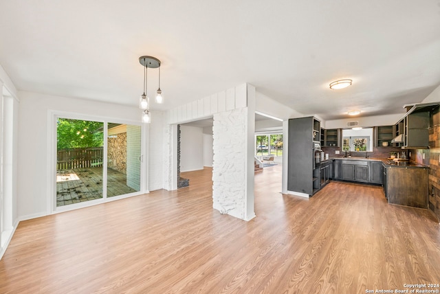 kitchen with decorative light fixtures, light hardwood / wood-style floors, and plenty of natural light