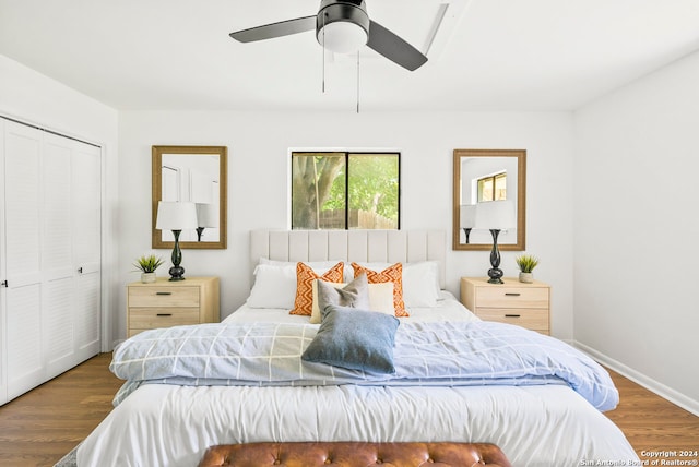 bedroom featuring wood-type flooring, ceiling fan, and a closet