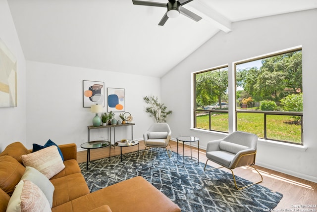 living room featuring hardwood / wood-style floors, ceiling fan, and vaulted ceiling with beams