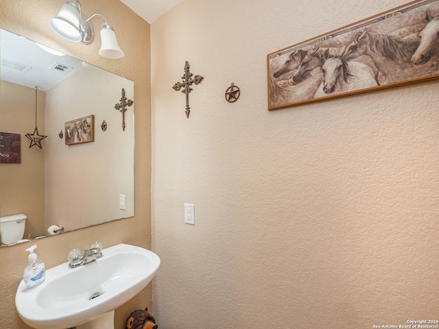 bathroom featuring sink and toilet