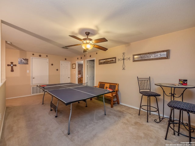 playroom with ceiling fan and light carpet