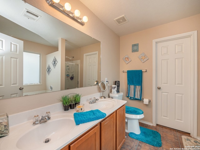 bathroom featuring vanity, an enclosed shower, and toilet