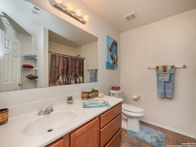 bathroom with vanity, tile patterned floors, toilet, a textured ceiling, and curtained shower