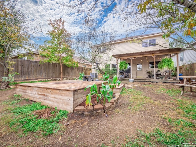 view of yard featuring cooling unit and a wooden deck