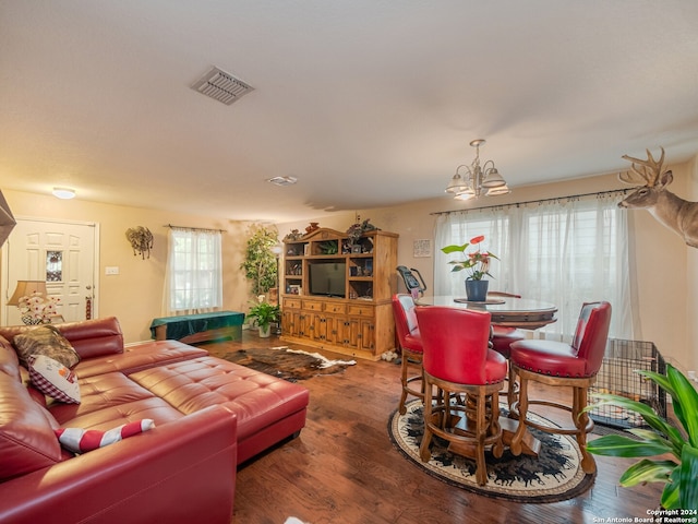 living room featuring an inviting chandelier and hardwood / wood-style flooring