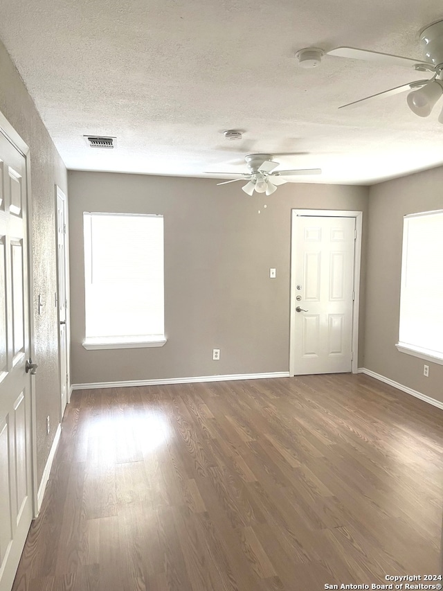 unfurnished room with ceiling fan and dark hardwood / wood-style floors