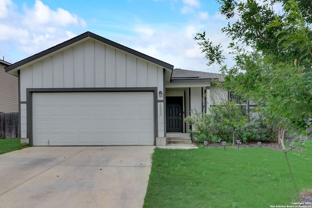 ranch-style house featuring a garage and a front lawn