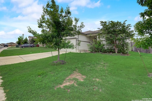 view of front of home with a front lawn and a garage