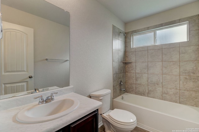 full bathroom featuring vanity, toilet, and tiled shower / bath