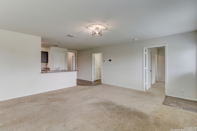 unfurnished living room with light carpet