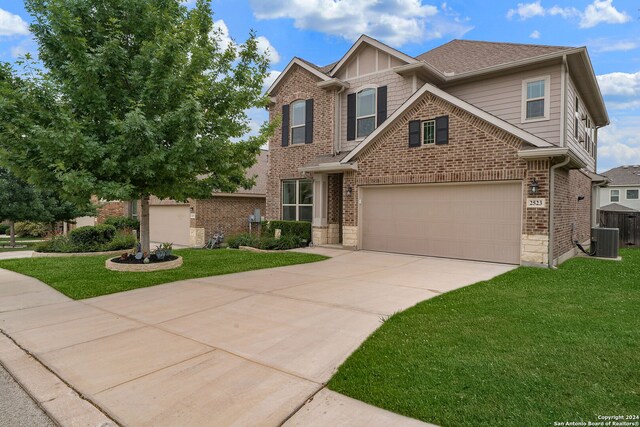 craftsman-style house with central AC, a front lawn, and a garage