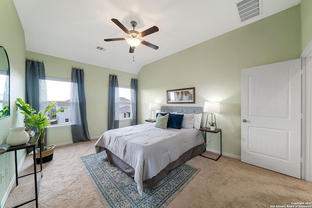 bedroom featuring light colored carpet, lofted ceiling, and ceiling fan