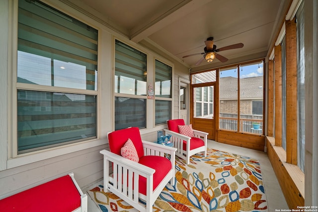 sunroom featuring ceiling fan