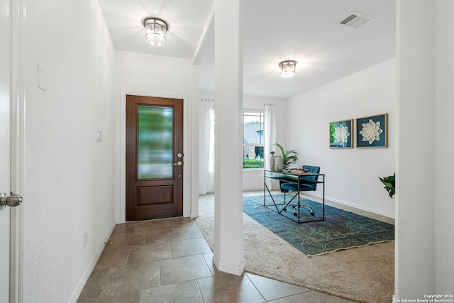 entryway with carpet floors