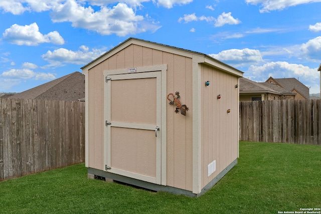 view of outdoor structure featuring a lawn