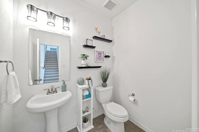 bathroom with toilet and tile flooring