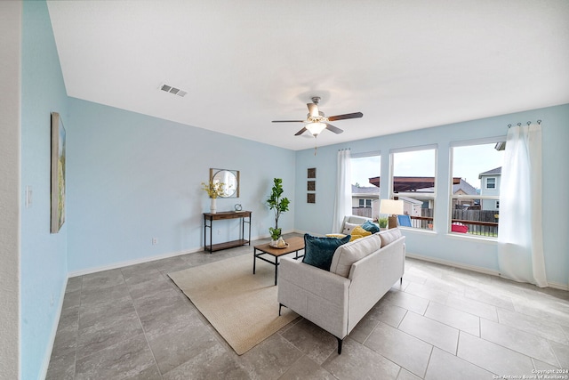 living room with ceiling fan and light tile flooring