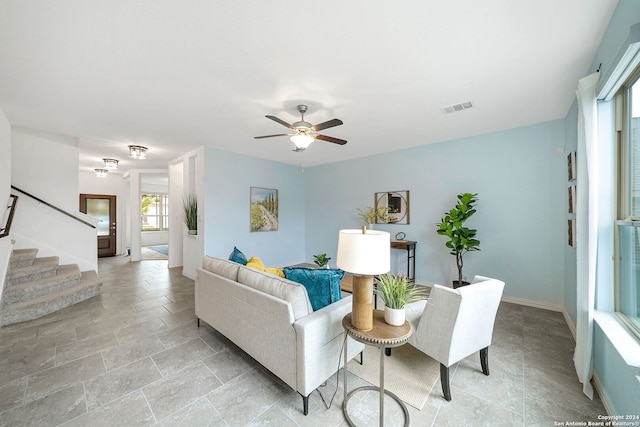 living room with ceiling fan and light tile flooring