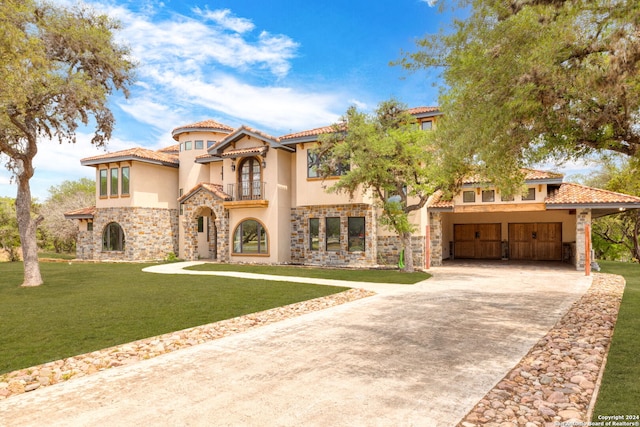 mediterranean / spanish-style house featuring a carport, a balcony, and a front yard