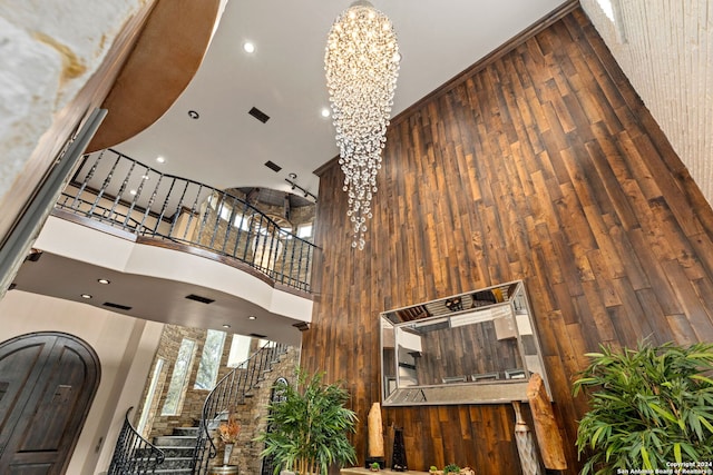 interior space featuring a notable chandelier, a towering ceiling, and hardwood / wood-style flooring