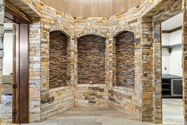 wine room with hardwood / wood-style flooring and ornamental molding