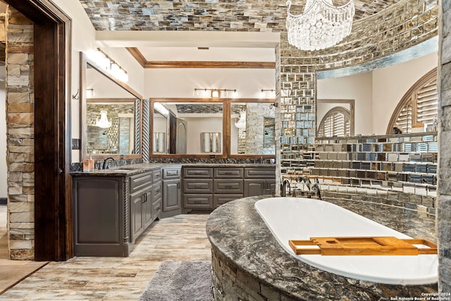 bathroom with tasteful backsplash, a tub, crown molding, a chandelier, and hardwood / wood-style flooring