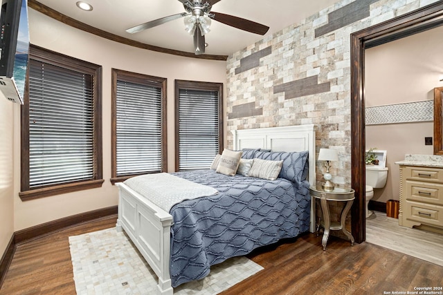 bedroom with ceiling fan, dark hardwood / wood-style flooring, crown molding, and multiple windows