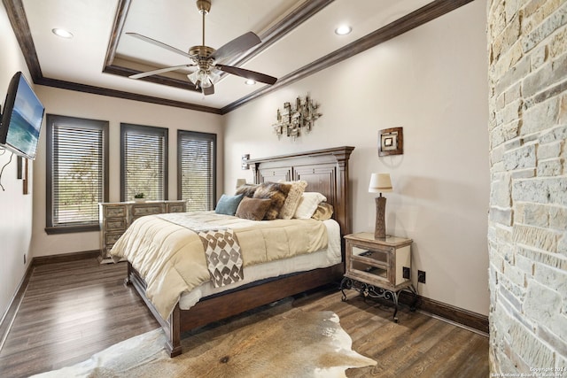 bedroom featuring a tray ceiling, ceiling fan, dark wood-type flooring, and crown molding