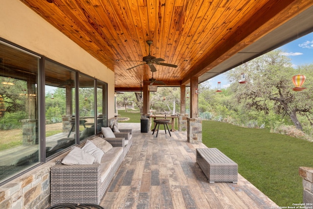 wooden deck with a yard, ceiling fan, and an outdoor hangout area