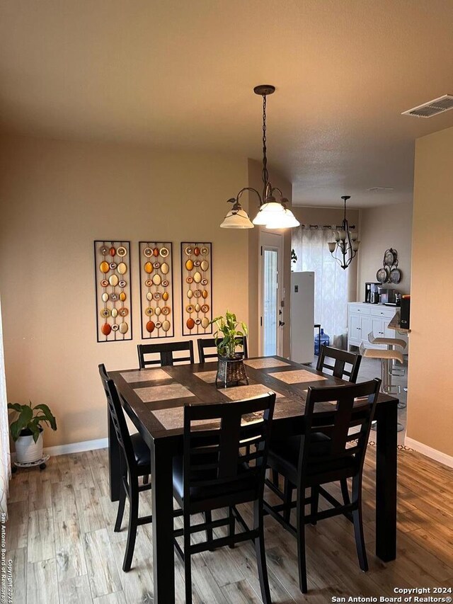 dining area featuring a chandelier and hardwood / wood-style floors