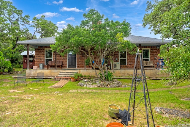 back of property with a yard and a porch