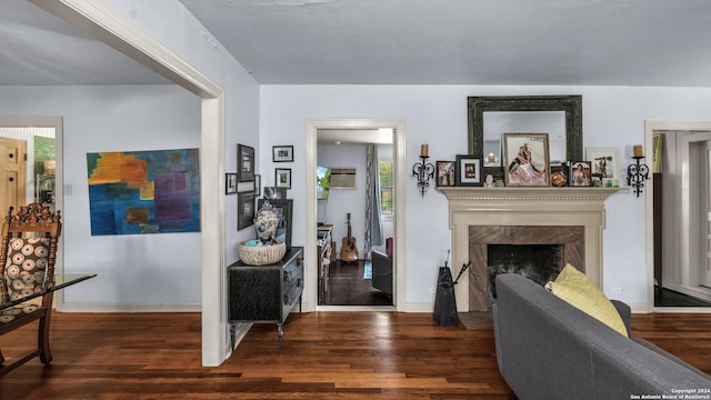 living room with dark hardwood / wood-style floors and a fireplace