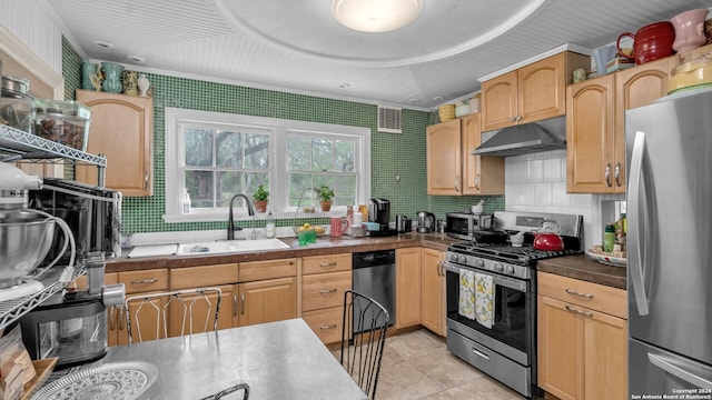 kitchen featuring tasteful backsplash, appliances with stainless steel finishes, light tile floors, and sink