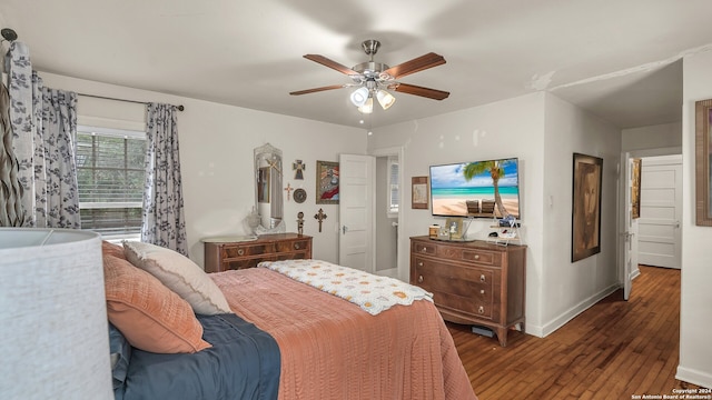 bedroom with ceiling fan and dark hardwood / wood-style floors