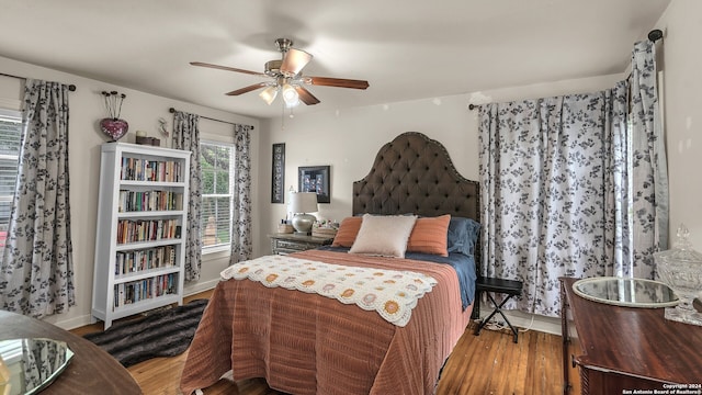 bedroom with wood-type flooring and ceiling fan