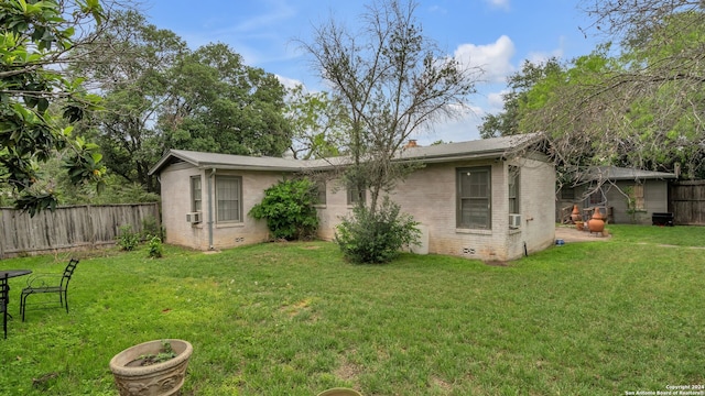 back of property featuring a lawn