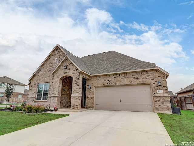 view of front of property with a garage and a front yard