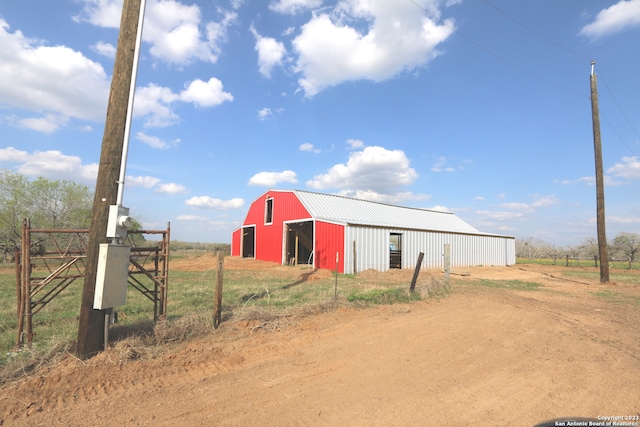 view of shed / structure featuring a rural view