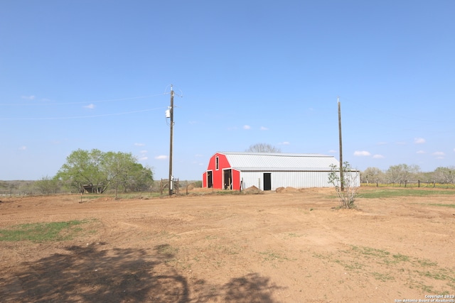 view of yard with a rural view and an outdoor structure